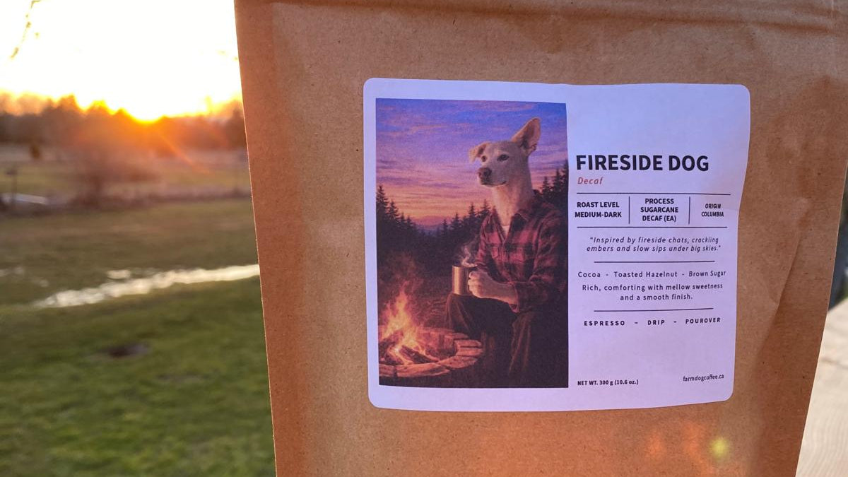 Brown coffee package with a label featuring a dog by a fire, set against a sunset landscape. New decaf blend.